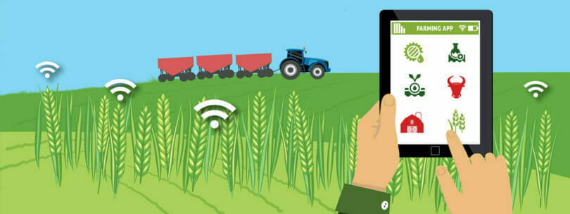 A person using a farming app on a tablet, monitoring crops with wi-fi signals and tractors in the background.